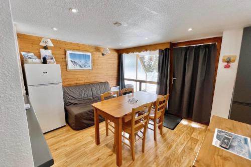 a kitchen and dining room with a table and a couch at The climber at Chamrousse #CU in Chamrousse
