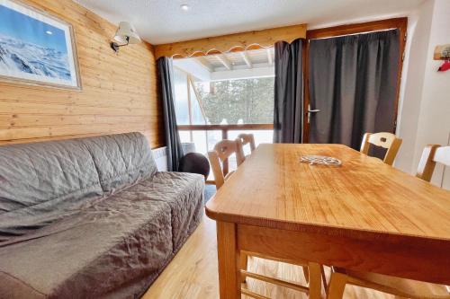a living room with a couch and a wooden table at The climber at Chamrousse #CU in Chamrousse