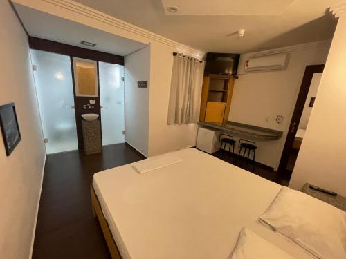 a small room with a bed and a bathroom at Hotel Estrela da Agua Fria in Sao Paulo