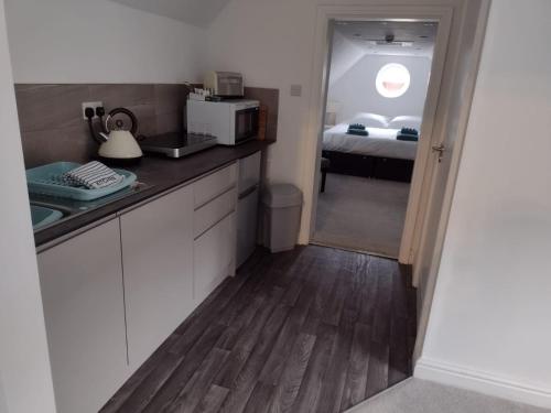 a kitchen with a counter and a bed in a room at The Wheatsheaf Inn in Atherstone