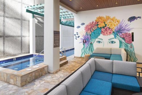 a rendering of a hotel lobby with a mural of a woman at Waikiki Malia in Honolulu