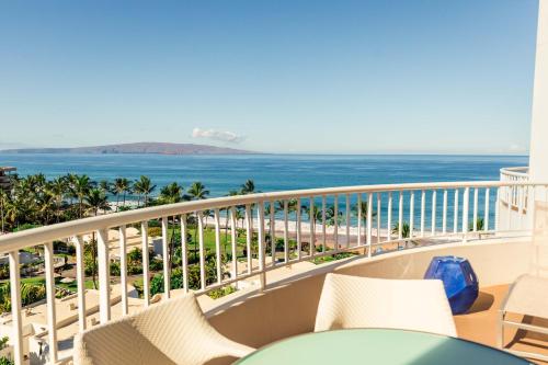 a balcony with chairs and a view of the ocean at Fairmont Kea Lani, Maui in Wailea