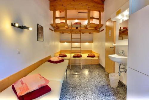 a room with two beds and a sink in a room at Hotel&Hostel Montarina in Lugano