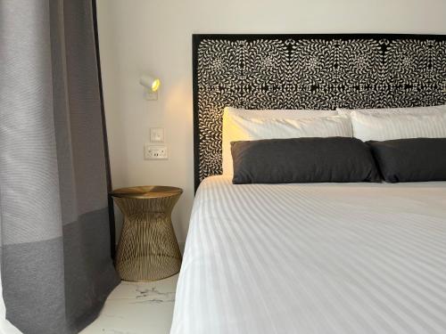 a bedroom with a bed with a black and white headboard at Apartments by Sliema promenade and beach in Sliema