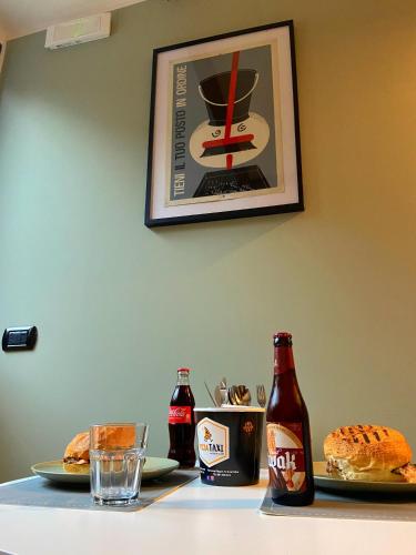 a table with two plates of food and two bottles of soda at Pozzuoli B&B exSofer in Pozzuoli