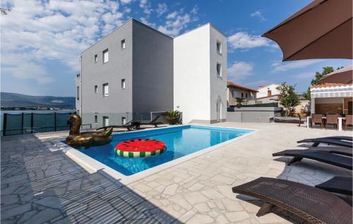 a swimming pool with a toy in the middle of a house at Nine-Bedroom Holiday Home In Arbanija in Trogir