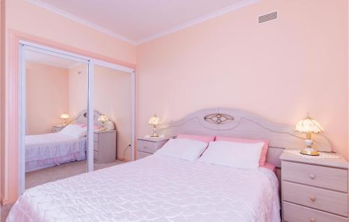 a white bedroom with a white bed and a mirror at 3 Bedroom Beautiful Apartment In Orasac in Orasac