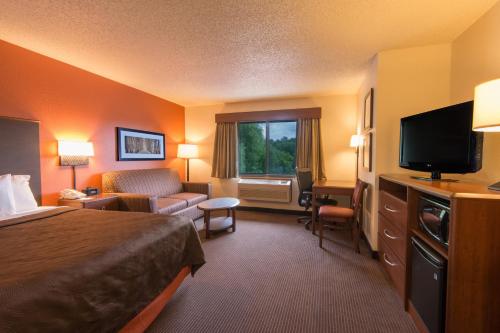 a hotel room with a bed and a television at AmericInn by Wyndham Minocqua in Minocqua
