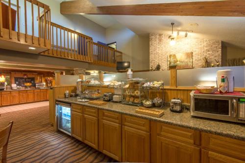 a kitchen with a large counter top and a large window at AmericInn by Wyndham Minocqua in Minocqua