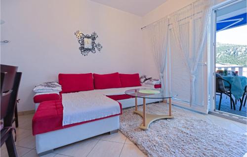 a living room with a red couch and a table at Two-Bedroom Apartment In Klek in Klek