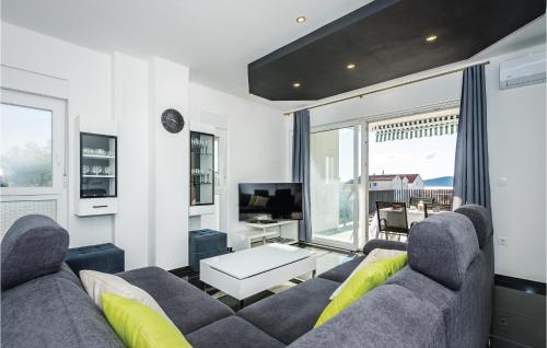 a living room with a couch and a tv at Three-Bedroom Holiday Home In Brodarica in Brodarica