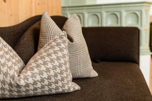 a group of pillows sitting on a couch at Apartments Villa Gardena - Gardenahotels in Selva di Val Gardena