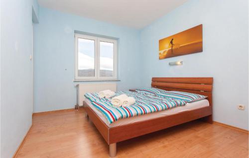a bedroom with a bed in a room with a window at Beautiful Apartment In Kornic With Kitchen in Kornić