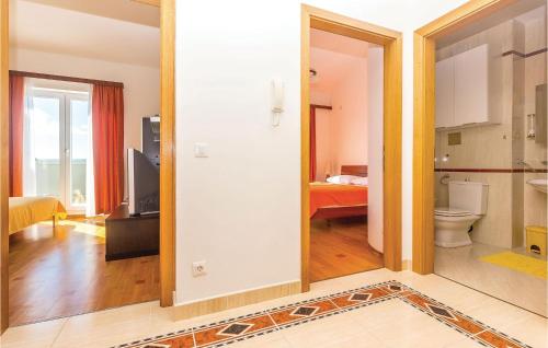 a room with a bathroom with a toilet and a bedroom at 2 Bedroom Stunning Apartment In Selce in Selce