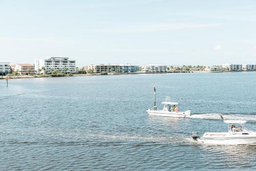 two boats in a large body of water at The Suites at Fishermen's Village - 2 Bedroom Suites in Punta Gorda