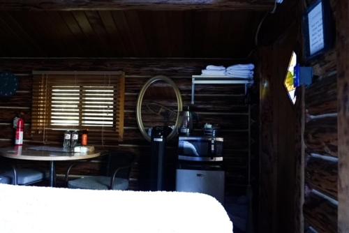 a room with a table and a mirror at Hope Alaska's Bear Creek Lodge in Hope