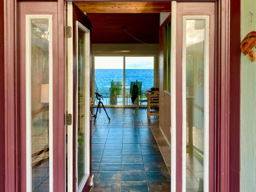 an open hallway with a view of the ocean from a house at Direct Oceanfront, Big Island Home in Keaau