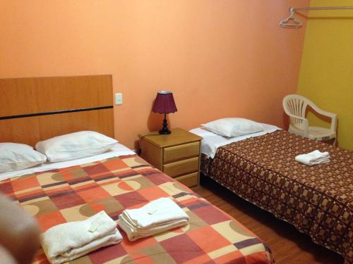 מיטה או מיטות בחדר ב-Hotel Sol de Huanchaco