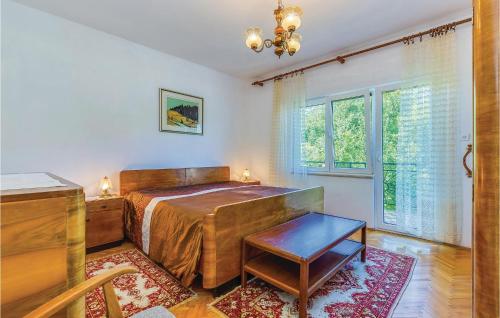 um quarto com uma cama, uma mesa e uma janela em Stunning Apartment In Tribalj With Kitchen em Tribalj