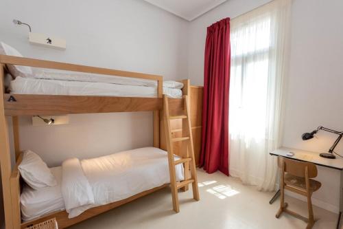 a room with two bunk beds and a desk and a window at City Circus Athens in Athens
