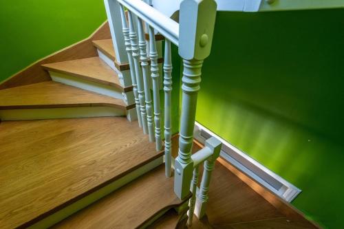a set of stairs in a room with green walls at City Circus Athens in Athens