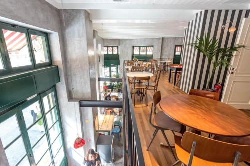 a room with tables and chairs in a restaurant at City Circus Athens in Athens