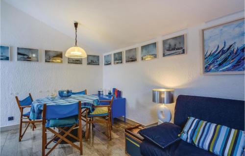 a living room with a table and a couch at Pet Friendly Home In Mali Losinj With Sauna in Mali Lošinj