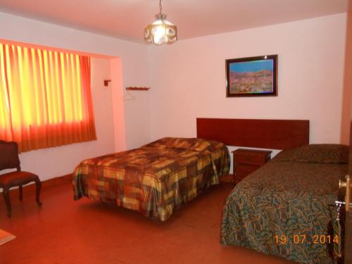 Postel nebo postele na pokoji v ubytování Hostal Cesar Alberto