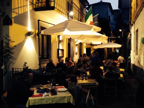 un grupo de personas sentadas en un restaurante por la noche en Hotel Persico, en Saluzzo