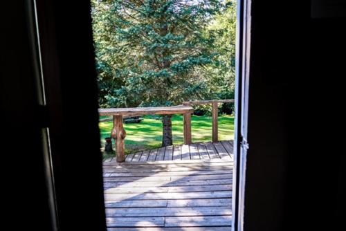 a view of a wooden deck with a bench at Hope Alaska's Bear Creek Lodge in Hope
