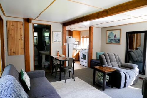 a living room with a couch and a dining room at Hope Alaska's Bear Creek Lodge in Hope
