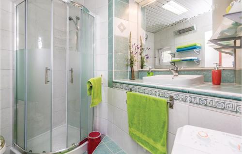 a bathroom with a glass shower and a sink at Gorgeous Apartment In Rijeka With House Sea View in Rijeka