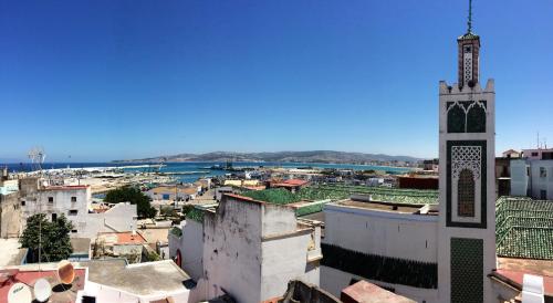 a view of a city with a clock tower at Dar Yasmine in Tangier