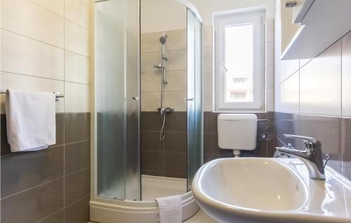a bathroom with a sink and a shower at Awesome Apartment In Premantura With 1 Bedrooms, Wifi And Outdoor Swimming Pool in Premantura