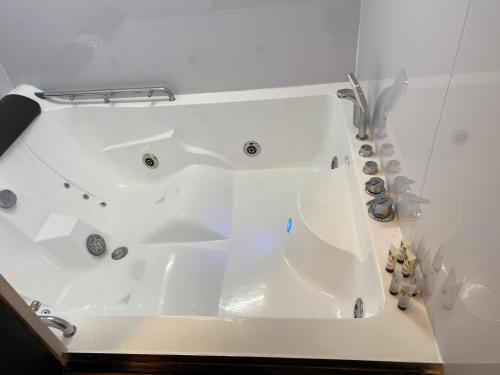 a white bath tub sitting in a bathroom at Wns HOTEL in London