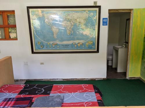 a map of the world hanging on a wall at Refugio en el Bosque in Medellín