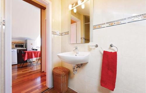 a bathroom with a sink and a red towel at Amazing Apartment In Vodice With 1 Bedrooms And Wifi in Vodice