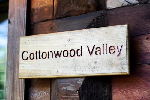 a wooden sign on the side of a wooden building at Hope Alaska's Bear Creek Lodge in Hope