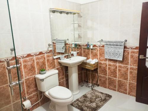 a bathroom with a toilet and a sink at Hospedaje de Marant in San Felipe de Puerto Plata