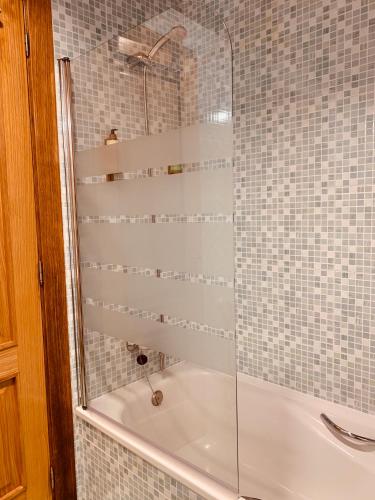 a shower with a glass door in a bathroom at Las Casitas de Santillana in Santillana del Mar