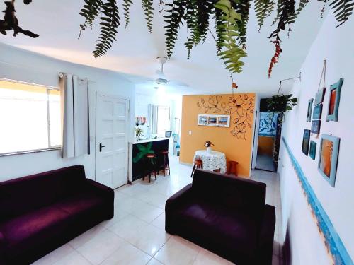 a living room with two couches and a table at Casa Mar Peruíbe in Peruíbe