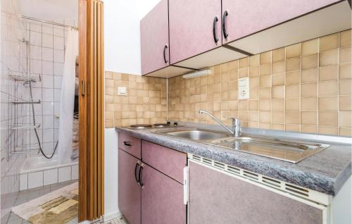 a kitchen with a sink and a shower at Lovely Apartment In Kampor With Kitchen in Kampor