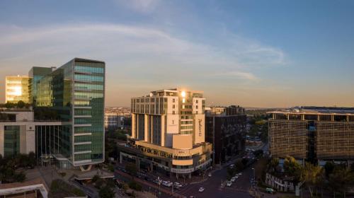 an aerial view of a city with tall buildings at Radisson Blu Gautrain Hotel, Sandton Johannesburg in Johannesburg
