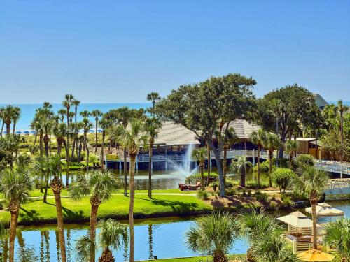 an aerial view of the resort with a pond and palm trees at Sonesta Resort - Hilton Head Island in Hilton Head Island