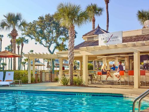 a hotel room with a pool and a beach at Sonesta Resort - Hilton Head Island in Hilton Head Island