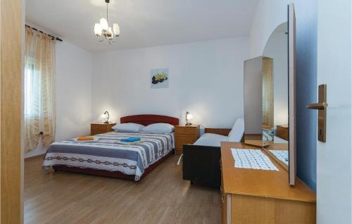 a bedroom with a bed and a desk and a mirror at Nice Apartment In Vir With 3 Bedrooms in Vir