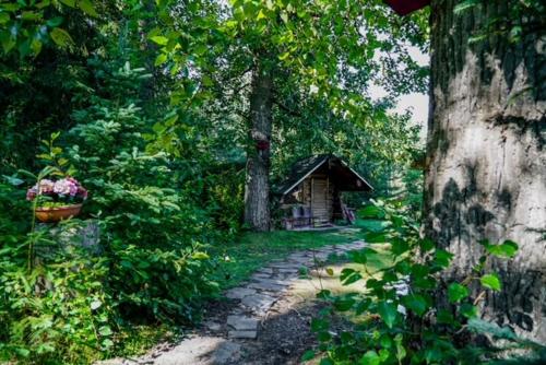 a painting of a path leading to a small cabin at Hope Alaska's Bear Creek Lodge in Hope