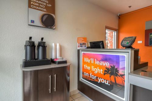 a room with a television with a sign on it at Motel 6-Arcadia, CA - Los Angeles - Pasadena Area in Arcadia