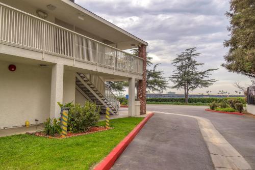 a building with a staircase next to a street at Motel 6-Arcadia, CA - Los Angeles - Pasadena Area in Arcadia