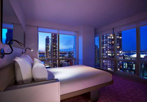 
a hotel room with a large window overlooking the ocean at YOTEL New York Times Square in New York
